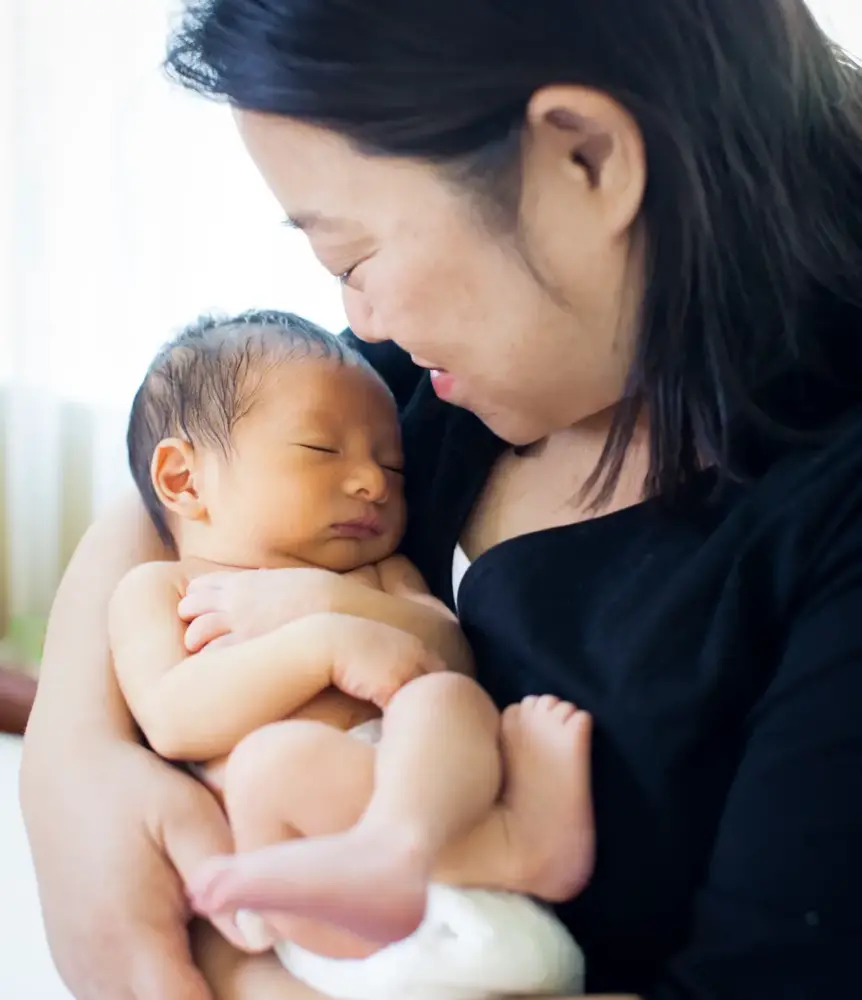 Mom cradling newborn baby