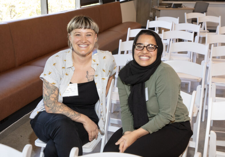 Two foundation employees smiling