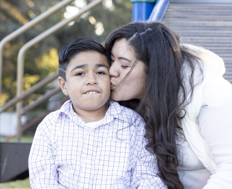 Danae Aguilar gives her brother a kiss on the cheek.