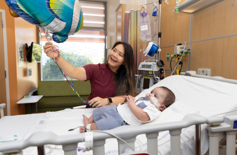 Infant patient with their Child Life Specialist.